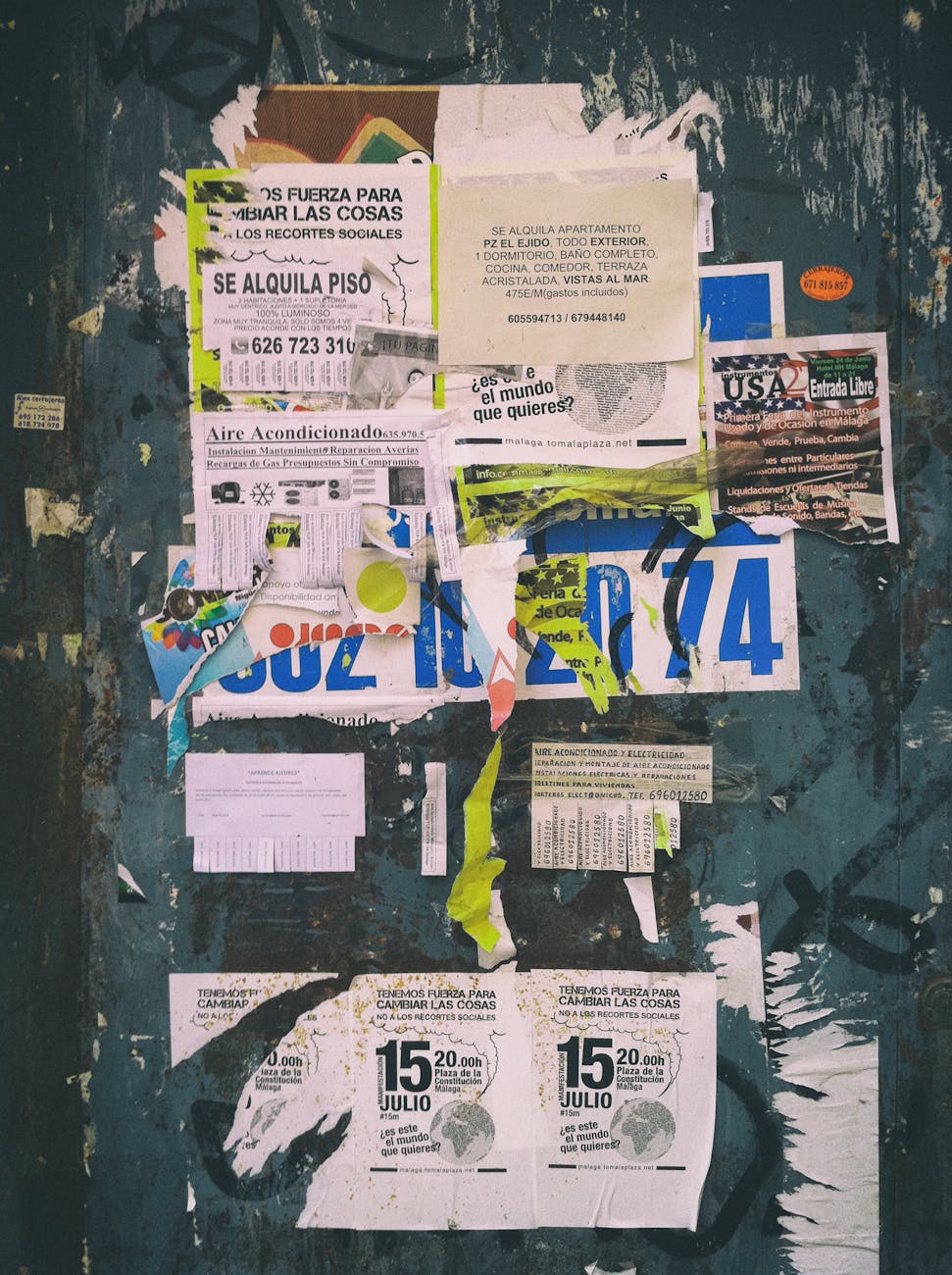 a collage of various posters and papers on a wall